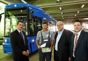 Zu guter Letzt: Mit der Übergabe der Frachtpapiere an KVG-Vorstand Norbert Witte (3. v.li.) endete heute Vormittag mit Wagen 672 die Anlieferung der jüngsten der 22 neuen Bahnen der KVG. Damit schloss sich zugleich der Kreis für das 55 Millionen Euro-Investitionsprojekt. Mit dabei: Karsten Kamutzki, Chef der gesamten KVG-Fahrzeugflotte (li). und Christian Schuppe (re.), Projektleiter für das Tram-Neubeschaffungsprogramm. Foto: nh